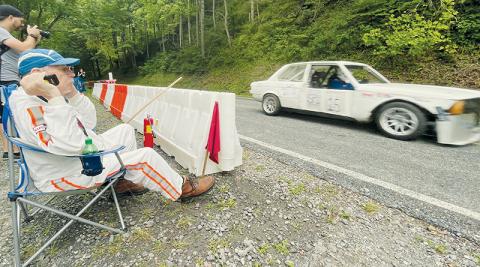 Asheville-area resident Mike Plemmons looks on as a car goes flying by during Saturday’s leg of the CCR-SCCA Dragon Hill Climb, which was held inside the Joyce Kilmer Memorial Forest. Plemmons has been involved with racing for over 40 years. Visit our Facebook page for more photos from Saturday’s portion of the event. Photos by Randy Foster/news@grahamstar.com