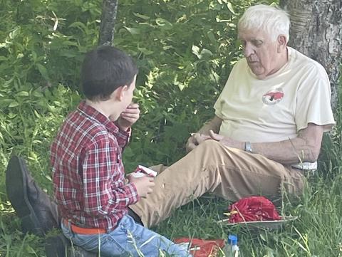Marshall Stewart, age 8, and Graham Star columnist Marshall McClung enjoy lunch after hiking to Oak Knob and Big Huckleberry on a recent 4-H trip. Photo courtesy of Nikki Stewart/Contributing Photographer