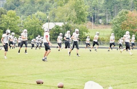 Members of the Robbinsville Black Knights begin pre-practice warm-ups Tuesday. Robbinsville kicks off the season Friday at Asheville High School. Photos by Kevin Hensley/sports@grahamstar.com