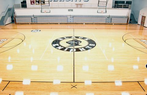 Lights glisten while showcasing the restored floor inside the Robbinsville High School gymnasium. The effort took a mere three weeks to complete. Photo by Kevin Hensley/sports@grahamstar.com