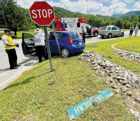 Emergency personnel attend to Martha Carpenter, whose car was involved in a collision at the intersection of Woodland Heights Road and Tallulah Road (U.S. Hwy. 129) around noon July 28. Photo by Randy Foster/news@grahamstar.com
