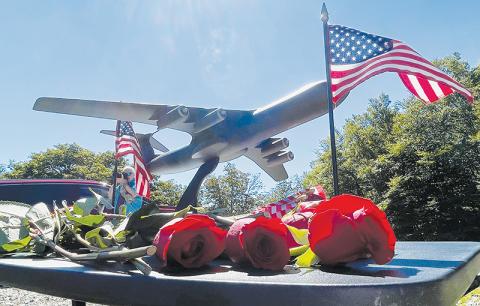 A model of a C-141B cargo jet sits on a pedestal amid roses and U.S. flags distributed to surviving family members of the crew of nine Air Force servicemen killed in a crash on Aug. 31, 1982, at a memorial service held on the 40-year anniversary of the tragedy. Photos by Randy Foster/news@grahamstar.com