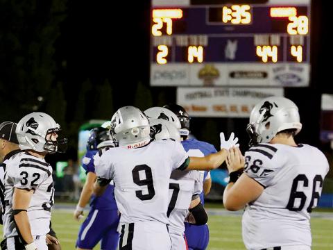 With the final outcome solidified on the scoreboard, Robbinsville’s Jude Campbell (32), Carson Lovin (9), Turner Jackson (7) and Haden Key (66) swarm Brock Adams after his victory-clinching interception Friday at Smoky Mountain. Photos by Miranda Buchanan/Robbinsville High School Yearbook
