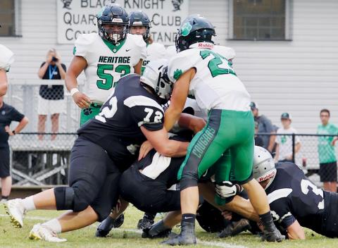 Robbinsville defenders – led by Tytan Teesateskie (72) and Caleb Draper (3) shut down the progress of Mountain Heritage quarterback Griffin Ray on Friday. For the second-straight week, the Knights’ defense held the opposition to single-digits, as Robbinsville picked up a 26-8 victory. Photos courtesy of Miranda Buchanan/Robbinsville High School Yearbook