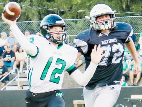 Black Knights’ lineman Dane Daniels (72) pursues Mountain Heritage quarterback Brayden Deyton during Aug. 25’s game against the Cougars. Photo courtesy of Carlos Lopez/Robbinsville High School