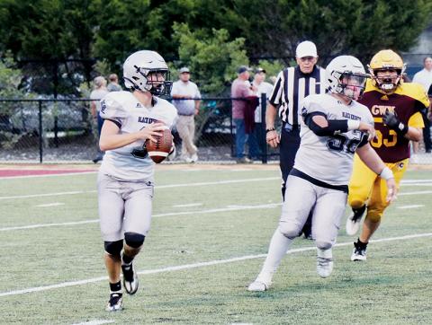 With Kellen Ensley (52) running interference, JV Black Knights quarterback Luke Lovin rolls out for a pass Sept. 8 at Cherokee. Photo courtesy of Haden Key/Robbinsville High School Yearbook