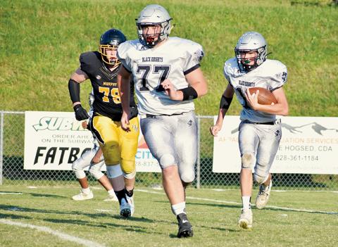 With Murphy’s Jude Pinkerton (78) in pursuit – and Robbinsville’s Owen Blevins (77) scanning the field for any signs of disruption – JV Black Knight Tillman Adams works his way upfield Sept. 15 at Murphy. Photo by Kevin Hensley/sports@grahamstar.com