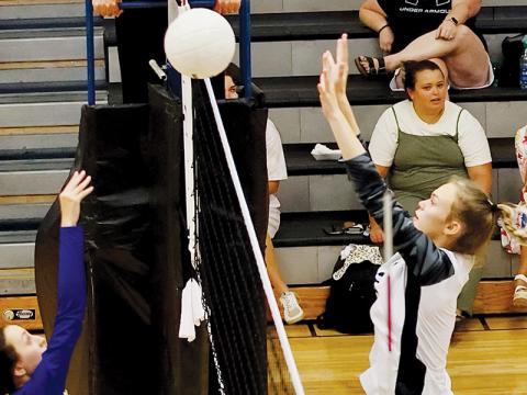 The work of Robbinsville’s younger varsity players – including Claire Barlow, shown contesting a Highlands return Aug. 23 – was crucial to the Knights’ clinching a four-set victory over Cherokee on Tuesday. Photo courtesy of Miranda Buchanan/Robbinsville High School Yearbook