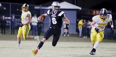 Sophomore quarterback Bryce Adams (6) finds some open room to advance during Friday’s loss to Murphy. Photo by Miranda Buchanan/Robbinsville High School Yearbook