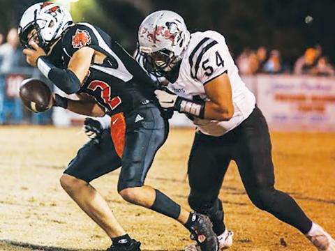 Senior lineman Carlos Lopez (54) attempts to bring down Andrews quarterback Donovan Carpenter during Robbinsville’s foray against the Wildcats on Friday. Photo courtesy of Haley Coffey