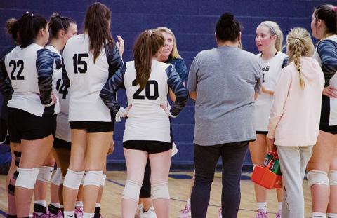 Head coach Kadey Phillips strategizes with the Lady Knights during a fifth-set timeout Tuesday, in the second round of the state playoffs at Highland Tech. Robbinsville fell to the No. 4-seeded Lady Rams, ending its season with 17 wins. Photo by Kevin Hensley/sports@grahamstar.com