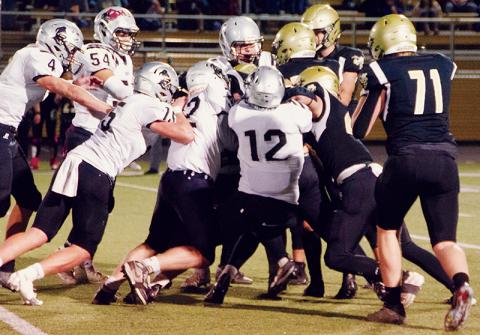 The Black Knights’ defense – led by Haden Key, Quinn Jumper, Jude Campbell, Roman Jones, Cuttler Adams and Carlos Lopez (clockwise from center) – swarm Hayesville’s Taylor McClure to stuff the Jackets’ top running threat Friday. Robbinsville held Hayesville to just 64 rushing yards on the night. Photos by Kevin Hensley/sports@grahamstar.com