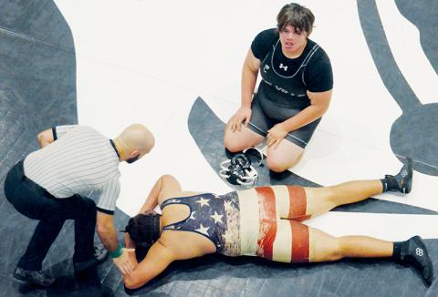 An exhausted Jacob Teesateskie glances at his raucous teammates Tuesday, as Madison’s Mason Clubb lays despondent on the mat. Teesateskie had just scored a takedown to prevail 7-5 in overtime against Clubb. Photos by Kevin Hensley/sports@grahamstar.com