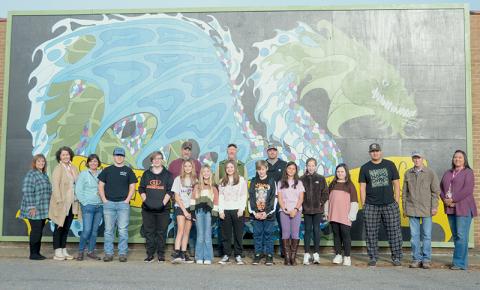 Participants in a summer art program at Robbinsville Middle School proudly stand with Graham County Schools’ faculty and staff Nov. 3, in front of a new mural that recently debuted on the side of a local shopping center. Photos by Kevin Hensley/editor@grahamstar.com