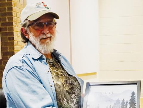 Dale Wiggins, former county commissioner and chairman of the Graham County Travel and Tourism board of directors, holds a certificate presented to him for his service on the board at the Dec. 1 meeting. Photo by Randy Foster/news@grahamstar.com