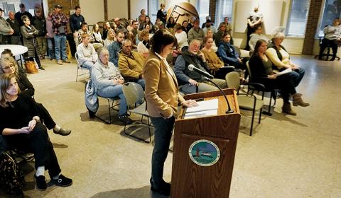 Becky Garland – standing at the podium during a Board of Health meeting on Nov. 21 – is a Cherokee County resident and Graham County Government finance director. She clocked out from her job so that she could argue on behalf of family planning services. Photo by Randy Foster/news@grahamstar.com