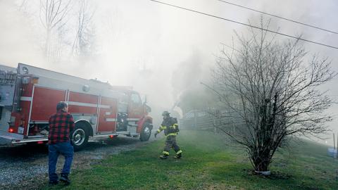 Unidentified firefighters prepare their gear while fighting a house fire at 1005 Hares Creek Road on Tuesday, Dec. 13. Photos by Randy Foster/news@grahamstar.com