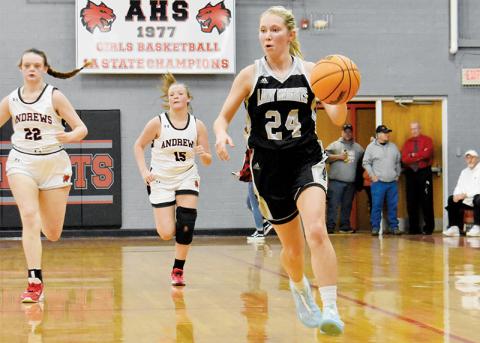 Lady Knights senior Kensley Phillips pulls away from the  defensive pursuit of Andrews’ Gracelyn Worley (22) and Demi Davis (15) on Tuesday. Photo by Kevin Hensley/sports@grahamstar.com