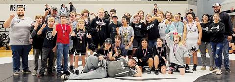 The Robbinsville Middle School wrestling team gathers to celebrate its 2022-23 Smoky Mountain Conference  tournament championship Dec. 15, moments after winning the title on their home mat.