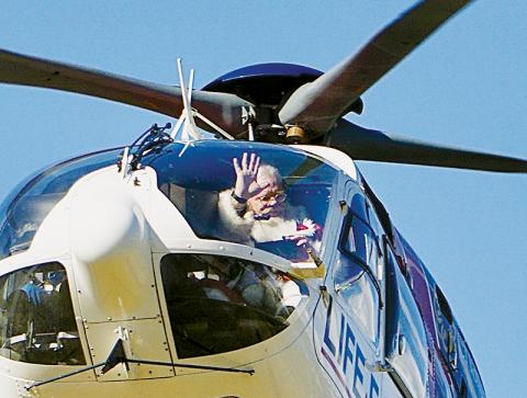 Santa Claus greets exuberant Robbinsville Elementary School children after  hitching a ride on a helicopter and landing on the 50-yard line at Big Oaks Stadium on Dec. 15. Photos by Randy Foster/news@grahamstar.com