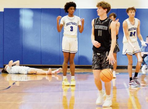 Black Knights junior Donovan Carpenter (11) was more than willing to pull away from Brevard’s Baker Buchanan (on the floor), Tre Crite (3) and Jaylen Brown (24) on Dec. 29, after Carpenter escaped with the game-clinching steal at the buzzer. Photo by Kevin Hensley/sports@grahamstar.com