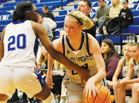 Robbinsville senior Kensley Phillips (right) drives past Brevard’s Shaniya Cook during Dec. 29’s Smoky Mountain Christmas Invitational appointment with the Lady Devils. The Lady Knights’ shooting guard was all over the floor in the lopsided victory,  picking up her first career triple-double in the process. Photos by Kevin Hensley/sports@grahamstar.com