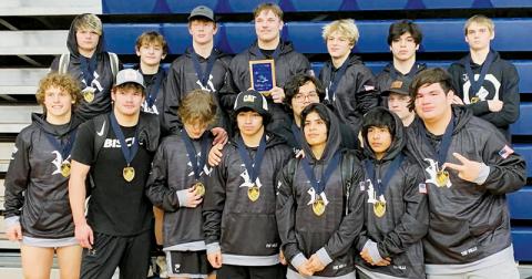 Members of the Robbinsville High School gather around the championship plaque the Black Knights  collected Saturday, after going 5-0 and winning the Enka Duals in Candler. Photo courtesy of Robbinsville Wrestling
