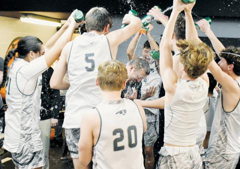 Members of the Black Knights mob head coach Jake Beasley in the locker room Tuesday, moments after Robbinsville wrapped up its first Smoky Mountain Conference title since the 2013-14 season. Photo by Kevin Hensley/sports@grahamstar.com