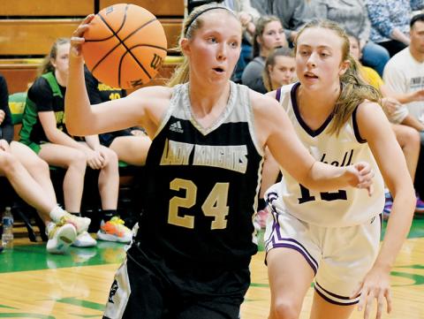Kensley Phillips cuts past Mitchell's Mary Beth Woody during the second half of the 1A West/Midwest All-Star Game on Saturday. Photo by Kevin Hensley/sports@grahamstar.com