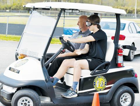 Under the direction of Graham County Sheriff Brad Hoxit, Robbinsville High School junior Bruce Helms drives through a makeshift obstacle course adjacent to the institution’s track April 5. The demonstration was made possible with help from the STAND T.A.L.L. organization. Photos by Kevin Hensley/editor@grahamstar.com