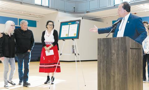 Sharon and David Crowe (far left) gaze in amazement at their respective Order of the Long Leaf Pine awards, which were presented in a surprise ceremony May 3 at the Jacob Cornsilk Community Center. Standing next to the couple is Order of the Long Leaf Pine Board Member; at the podium is N.C. Bureau of Indian Affairs Executive Director Greg Richardson. Photos courtesy of Maria Shook Photography