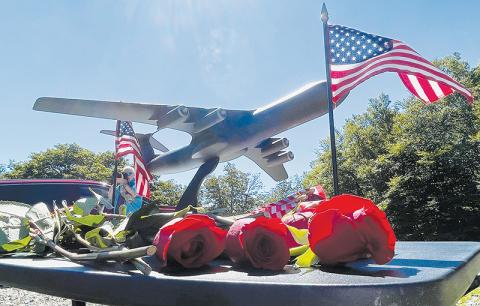 A model of a C-141B cargo jet sits on a pedestal amid roses and U.S. flags distributed to surviving family members of the crew of nine Air Force servicemen killed in a crash on Aug. 31, 1982, at a memorial service held on the 40-year anniversary of the tragedy. Coverage of the service received a second-place award at the state level. Photo by Randy Foster/Community Newspapers, Inc.