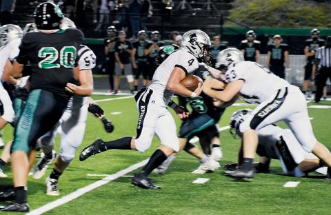 Robbinsville’s Cuttler Adams emerges for an eventual 29-yard touchdown run that would cement the Knights’ 28-17 win at Mountain Heritage on Friday. Adams now has 5,075 rushing yards in his career. Photos by Kevin Hensley/sports@grahamstar.com