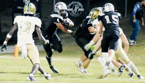 Senior running back Cuttler Adams pokes through an open spot during the second half of Friday’s home loss to Rabun Gap, Ga. Photos by Danielle Crabtree/The Graham Star