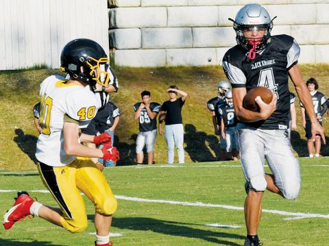 Under the pursuit of Murphy’s Brodie Betts, JV Black Knight Cameron Allison eyes a cut upfield during Sept. 7’s home tilt with the Bulldogs. Photo by Danielle Crabtree/The Graham Star