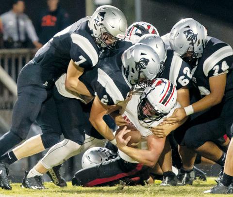 Members of the Black Knights’ defense – Blake Powers (7), Chase Calhoun (2),  Jonah Teesateskie (62) and John Dominguez (74) – crunch Andrews senior running back Dalton Rose during Friday’s homecoming win over the Wildcats. Photos courtesy of Maria Shook Photography