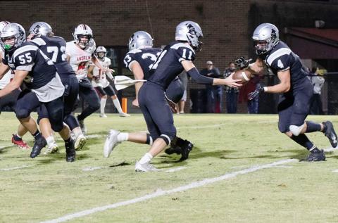 Robbinsville's Donovan Carpenter (11) delivers a handoff to Cuttler Adams during the waning moments of the first half Friday against Andrews. The Black Knights scalded the Wildcats 36-19 on homecoming. Photo courtesy of Maria Shook Photography