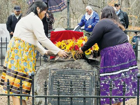 Cecilia Arrowwood (left) and Jenni Junaluska place the ceremonial wreath on Junaluska’s grave Friday. Photos by Latresa Phillips/The Graham Star
