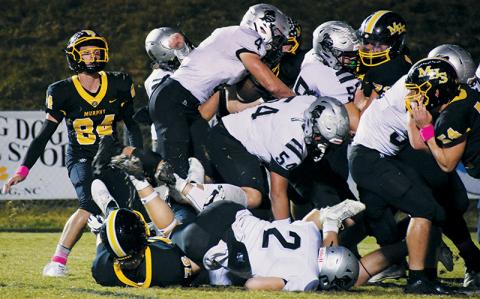 Robbinsville senior Cuttler Adams leaps across a mixture of limbs Oct. 6 at Murphy. In the first round of the state playoffs Friday, Adams broke the all-time rushing record for both the Black Knights and the Smoky Mountain Conference. Photo by Kevin Hensley/sports@grahamstar.com