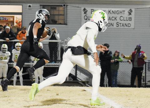 With nothing but open real estate in front of him, Robbinsville senior Cuttler Adams glances over at North Rowan’s Jarmais Morrow en route to a huge gain Friday against the Cavaliers. Adams set another rushing record in the game, while also tallying four touchdowns in the fourth round of the postseason. Photo courtesy of Faith Broome/Contributing Photographer