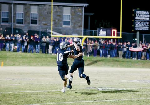 Knowing the outcome of the play was fully in the bag, Robbinsville senior Cuttler Adams reaches back for a high five from Tanner Hedden during his 102-yard interception return for the game-winning touchdown in the late stages of Friday’s win over Swain County. The victory solidified the Black Knights’ 27th divisional title. Photos by Miranda Buchanan/Robbinsville High School Yearbook