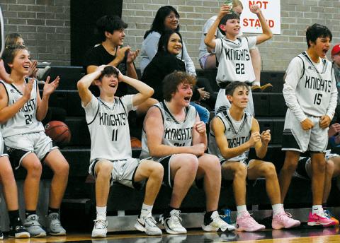 Members of the Robbinsville Black Knights erupt in celebration of Peyton Brooks’ late-game bucket in Monday’s season opener against Murphy. From left are Peyton Weaver (24), Bam Nelms (11), Landen Eddings, Eli Lambert, Carsan Snider (22) and Xamuel Wachacha (15). Photo by Kevin Hensley/sports@grahamstar.com
