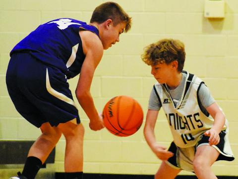 Tim Grant (14) swats the ball out of Camren Robinson's possession during Robbinsville's rout over Martins Creek on Nov. 20. Photo by Kevin Hensley/sports@grahamstar.com