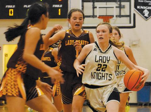 Daphne Barlow (22) cuts between the defense of  Cherokee’s Cambry Stamper (1) and Lilly Lossiah during a fourth-quarter, fast-break Monday. Photo by Kevin Hensley/sports@grahamstar.com