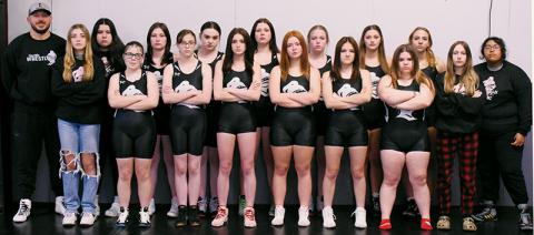 The 2023-24 Robbinsville Lady Knights varsity wrestling team. Names are listed from left. Front row: Nora Thomas, Koda Stinson, Anna Norris, Andrea Sheeks, Jayce Shuler, Velvet Carver, Hailey McLucas and Haley Burchfield. Back row: head coach Josh Winfrey, Alex Parton, Pacey Bradshaw, Kenzie Belk, Kaley Lofty, Kyla Jenkins,  Campbell Brooks, Alexis El-Khouri and Jennifer Guzman. Not pictured is assistant coach Sarah Orr. Photo by Kevin Hensley/sports@grahamstar.com