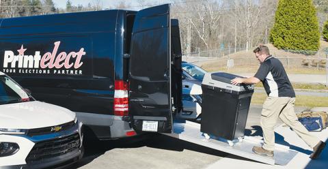 Service technician Chris Kingsbury loads up one of the 11 Print-Elect machines demonstrated in the Dec. 7 mock election. Photo by Ruby Annas/news@grahamstar.com