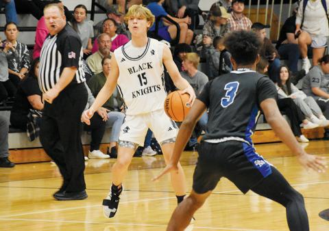 Dane Knott shouts instructions to the Black Knights in the ealry moments of Robbinsville’s win over Smoky Mountain on Dec. 7. A sophomore, Knott has taken the reins as the Knights’ point guard this season. Photos by Fala Welch/The Graham Star