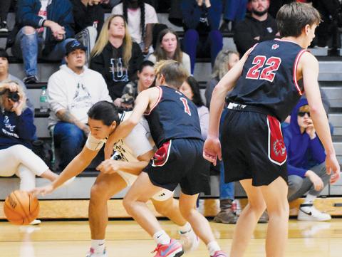 Robbinsville’s Quinn Jumper ducks around Andrews’ Gabe Clark during the Black Knights’ win over the Wildcats on Tuesday. Photo by Fala Welch/The Graham Star