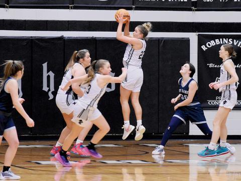 Liz Carpenter pulls down a rebound during Tuesday’s season opener against Nantahala. The junior small forward finished the game with a team-best 19 points. Photos by Fala Welch/The Graham Star
