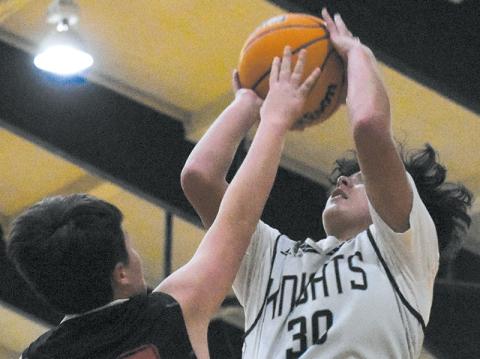 Elijah Kirkland seemingly reaches into the lights – and over the plea of Andrews’ Tanner Postell – for two of his Black Knights-best 15 points in Dec. 14’s home win over the Wildcats. Photo courtesy of Jozlyn Garland/Contributing Photographer